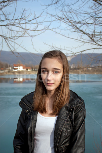 stock photo: teenage girl in black leather jacket by the lake