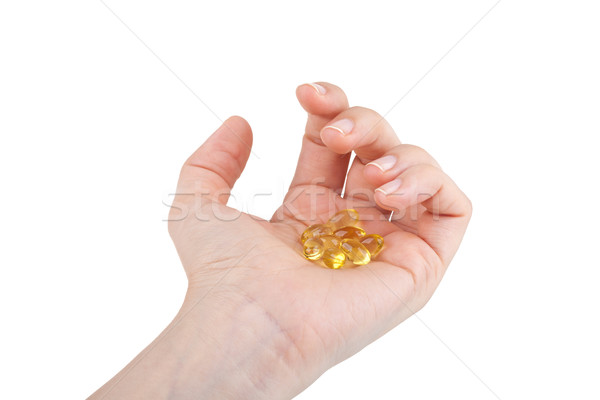 Cod liver oil pills in hand Stock photo © gsermek
