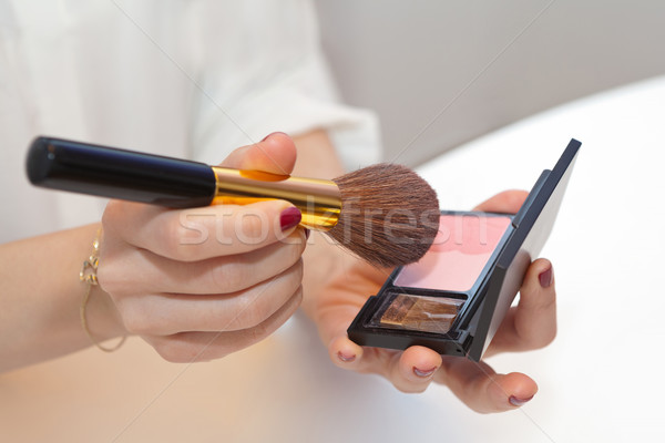 Professional make up brush in hand on pink blush Stock photo © gsermek