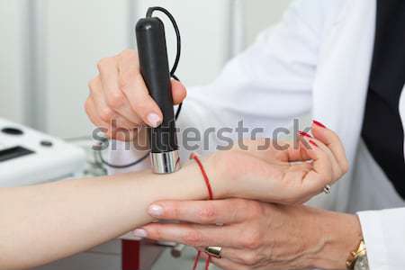 Dermatologist examining birthmarks and moles on a female patient Stock photo © gsermek