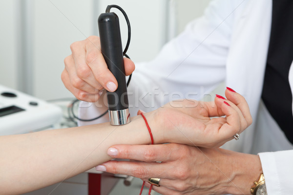 Dermatologist examining birthmarks and moles on a female patient Stock photo © gsermek