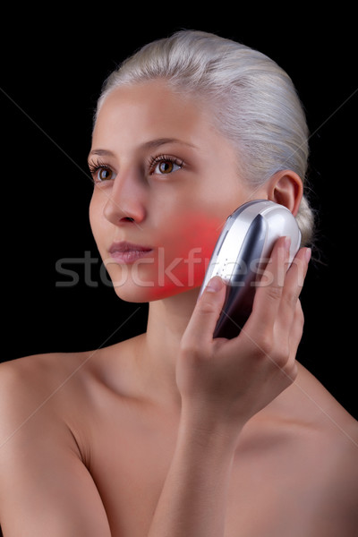 Young woman getting photo-therapy treatment with red light Stock photo © gsermek