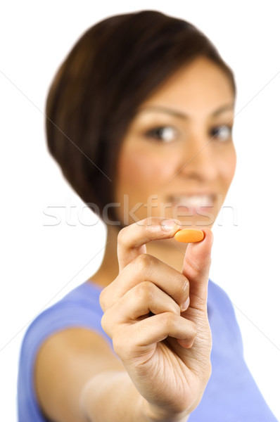 A young woman holds a nutritional supplement pill. Stock photo © Habman_18