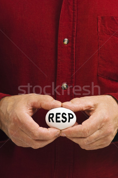 Stock photo: RESP written on egg held by man