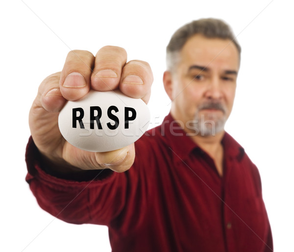 Mature man holds an egg with RRSP on it. Stock photo © Habman_18