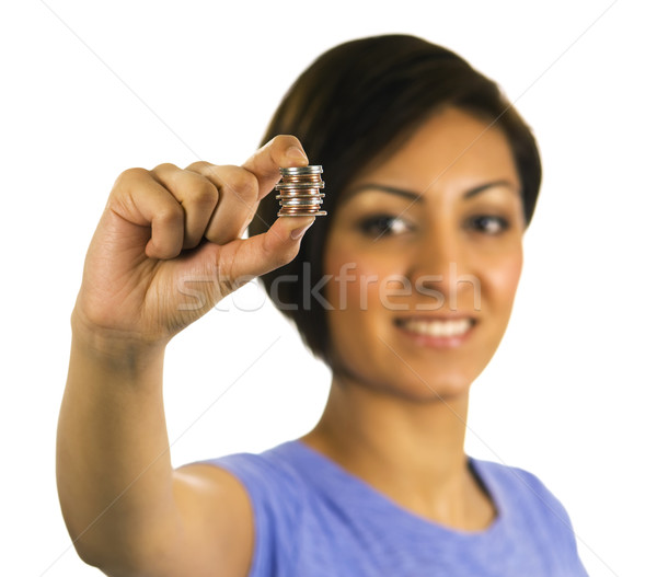 Young ethnic woman holds a stack of coins between her fingers. Stock photo © Habman_18