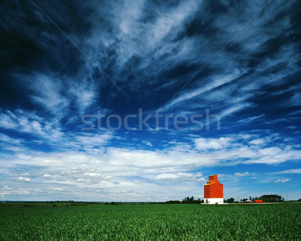 Stock photo: Orange grain elevator against a big blue sky.
