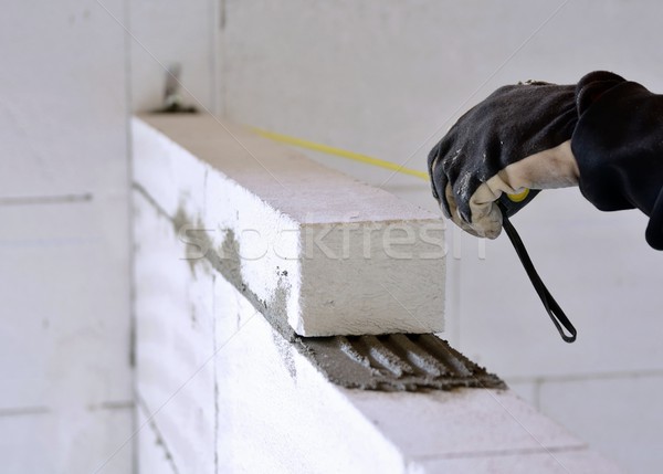 Bricklayer using a tape measure Stock photo © hamik