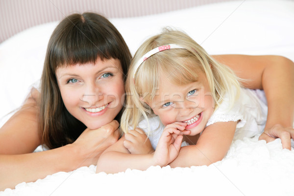 Mother and daughter posing happily in bed Stock photo © hannamonika