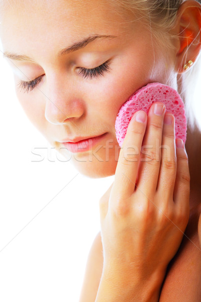 Stock photo: Beautiful young woman removing make-up
