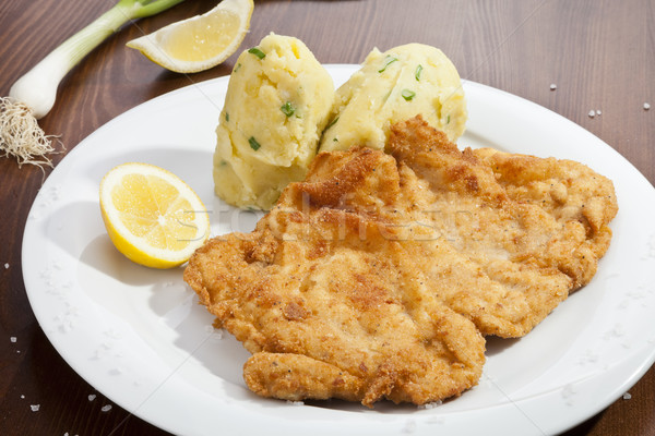 Vienna schnitzel with mashed potatoes and baby onion Stock photo © hanusst