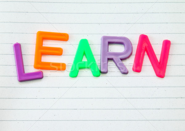 Learn in colorful toy letters on lined paper background  Stock photo © happydancing