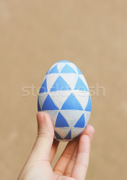 Hand holding color painted easter egg with retro filter tone Stock photo © happydancing