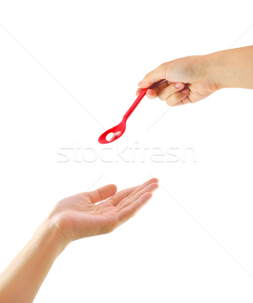 Hand giving medicine to other hand isolated Stock photo © happydancing