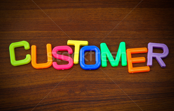 Customer in colorful toy letters on wood background Stock photo © happydancing