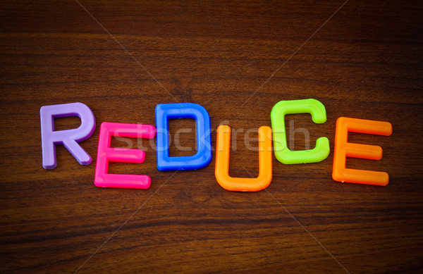 Reduce in colorful toy letters on wood background  Stock photo © happydancing