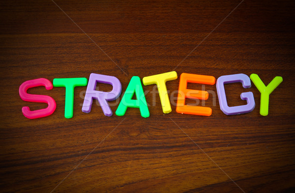 Strategy in colorful toy letters on wood background  Stock photo © happydancing