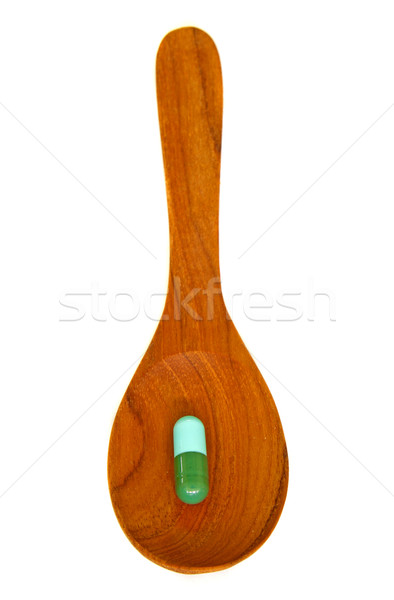 Wooden spoon with capsule  isolated on white background  Stock photo © happydancing