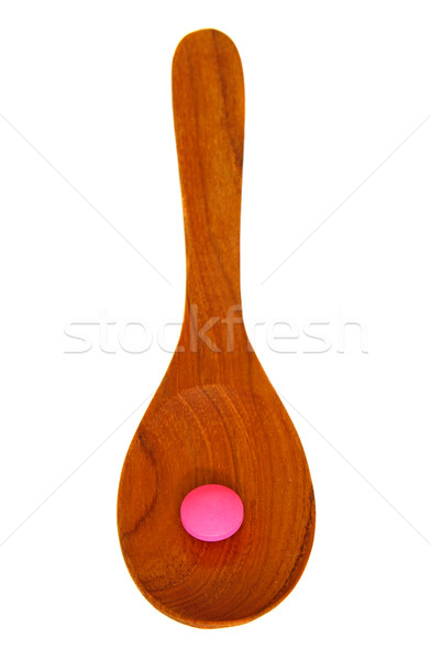 Wooden spoon with pill isolated on white background  Stock photo © happydancing