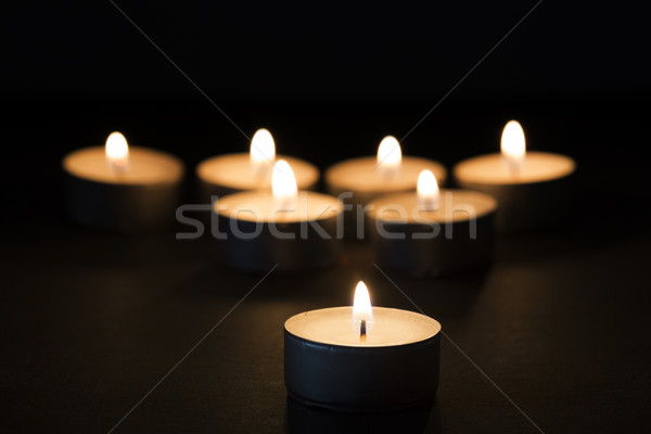 Burning tealights in darkness Stock photo © haraldmuc