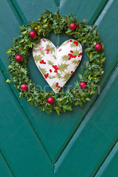 Stock photo: Christmas wreath hanged on a wooden door