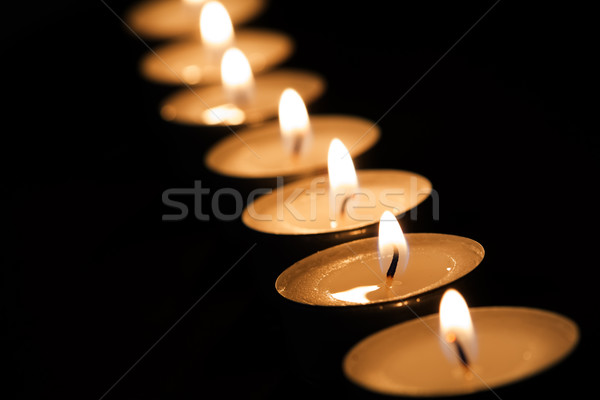 Burning tealights in darkness Stock photo © haraldmuc