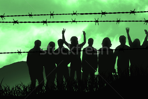 Drutu kolczastego ludzi za wojny drutu wolna Zdjęcia stock © Hasenonkel