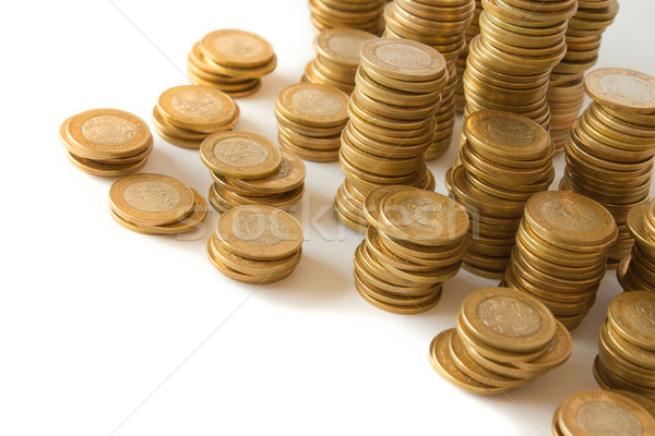 Piles of golden coins on white background, mexican ten pesos coins Stock photo © hayaship