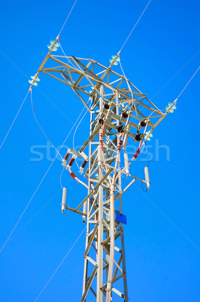 Detailed high voltage power line over brightly blue sky. Stock photo © HERRAEZ