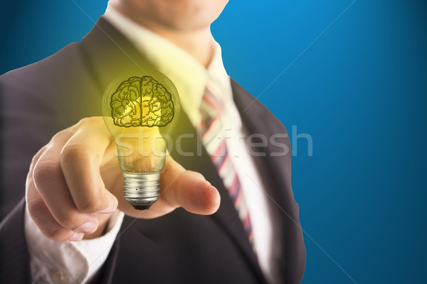 Businessman touching idea brain blub  Stock photo © hin255