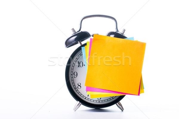 Stock photo: Note color paper stick on alarm clock