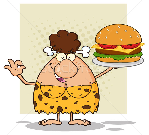 Smiling Brunette Cave Woman Cartoon Mascot Character Holding A Big Burger And Gesturing Ok Stock photo © hittoon