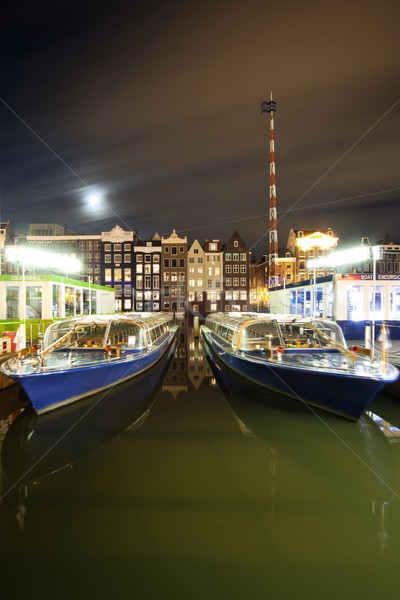 Amsterdam by night - excursion boat quay near Damrac street Stock photo © Hochwander
