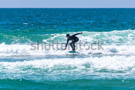 Long boarder surfing the waves at sunset Stock photo © homydesign