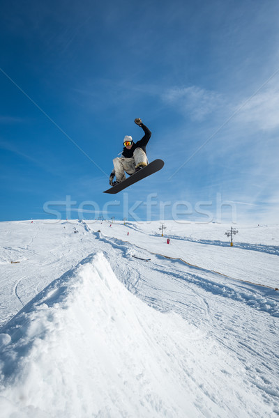 Snowboarder jumping against blue sky Stock photo © homydesign