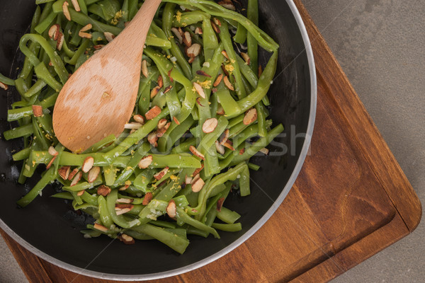 Green beans with roasted almonds Stock photo © homydesign