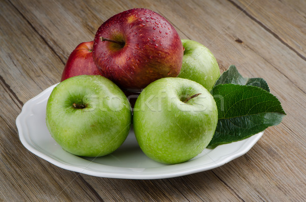 Apples in a ceramic white plate Stock photo © homydesign