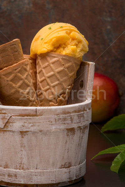Homemade mango ice cream in waffle cone Stock photo © homydesign