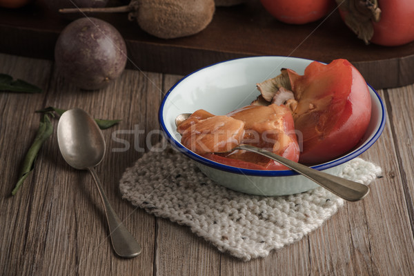 Persimmon fruit on rustic table Stock photo © homydesign