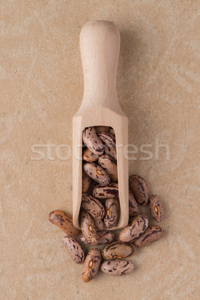 Wooden scoop with pinto beans Stock photo © homydesign