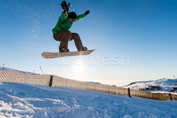 Stock photo: Snowboarder at jump