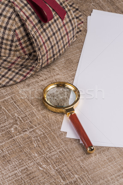 Paper sheets and magnifying glass Stock photo © homydesign