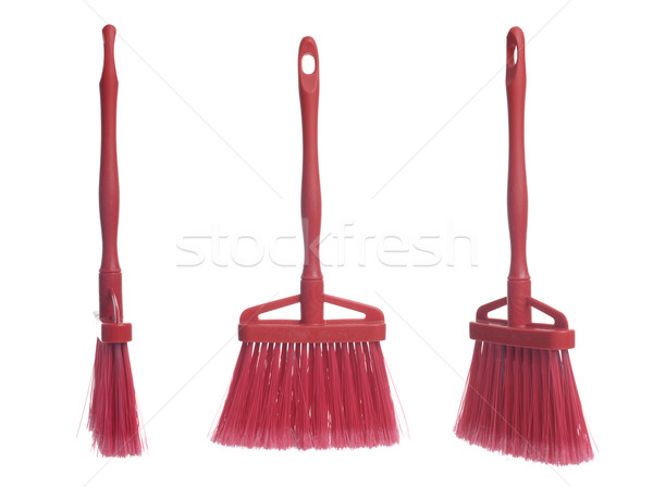 Three plastic red brooms Stock photo © homydesign