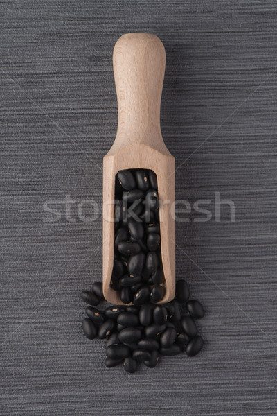 Wooden scoop with black beans Stock photo © homydesign