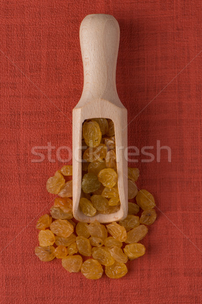 Wooden scoop with golden raisins Stock photo © homydesign