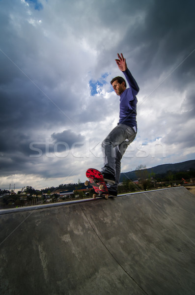 Skateboarder sombre nuages locale coucher du soleil sport Photo stock © homydesign
