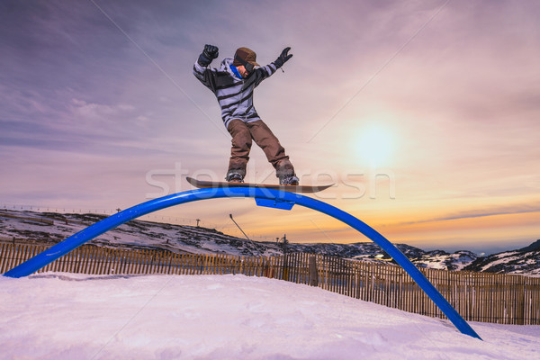 Snowboarder sliding on a rail Stock photo © homydesign