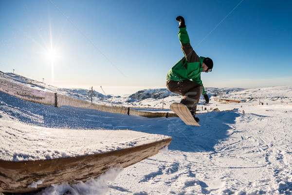 Snowboarder jumping against blue sky Stock photo © homydesign