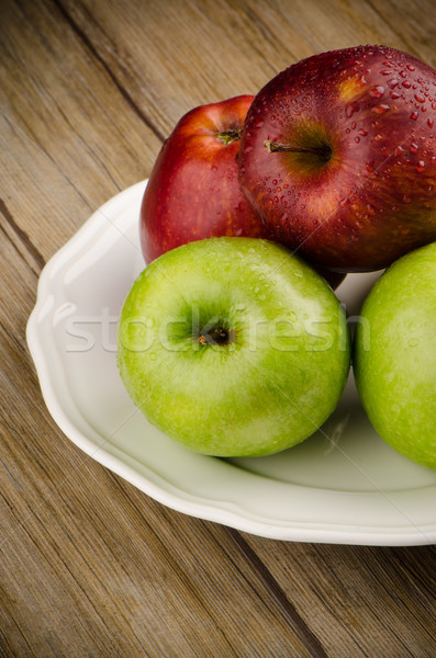 Apples in a ceramic white plate Stock photo © homydesign