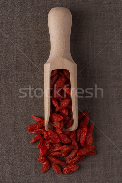 Stock photo: Wooden scoop with dry red goji berries